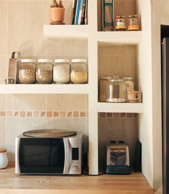 kitchen countertop and shelves with microwave and toaster